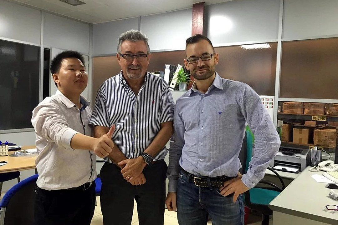 Group photo with two overseas visitors at a customer's office