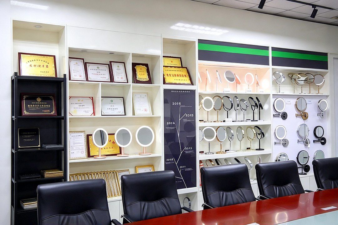 On the left, a timeline of the company's history; in the center, a display of honor certificates and medals; on the right, shelves holding a range of L…