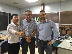 Visiting an overseas customer: with two client representatives in their office.