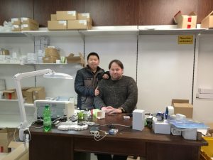 Visiting an overseas customer at their warehouse, shelves stocked with boxed LED lamps.